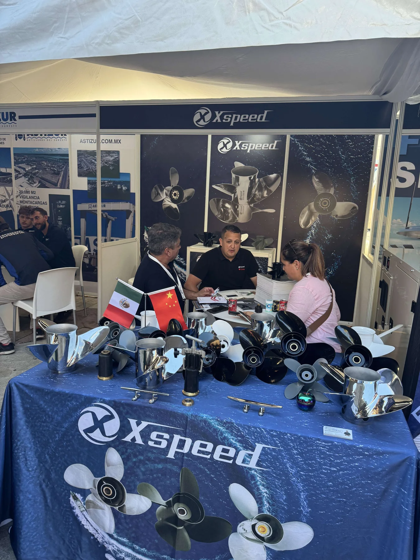 Business meeting at the Xspeed booth during the 2025 Cancun International Boat Show