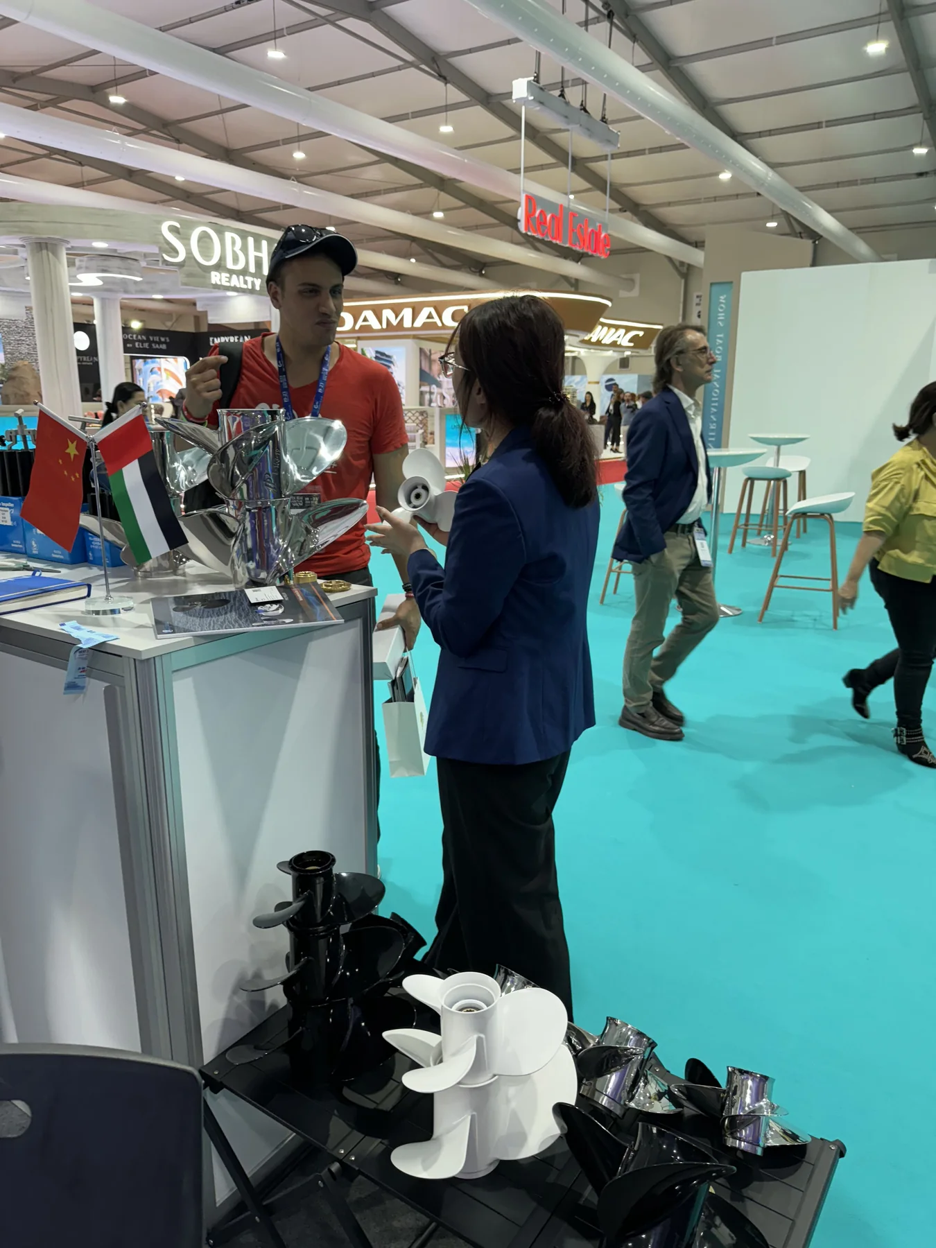 Xspeed representative discussing stainless steel propellers at Dubai International Boat Show