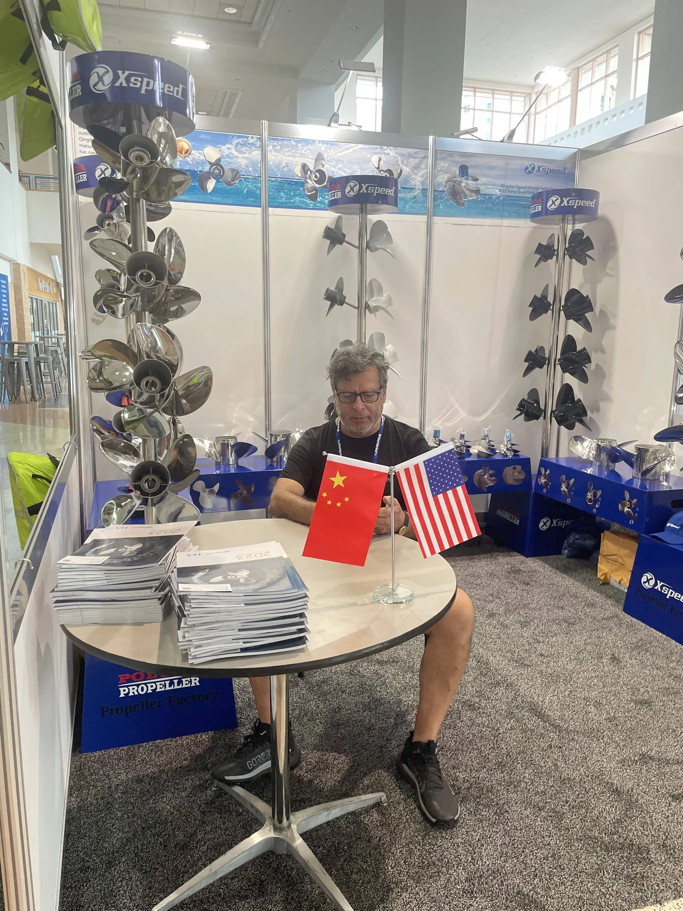 Visitor reviewing the Xspeed propeller catalog at IBEX Tampa