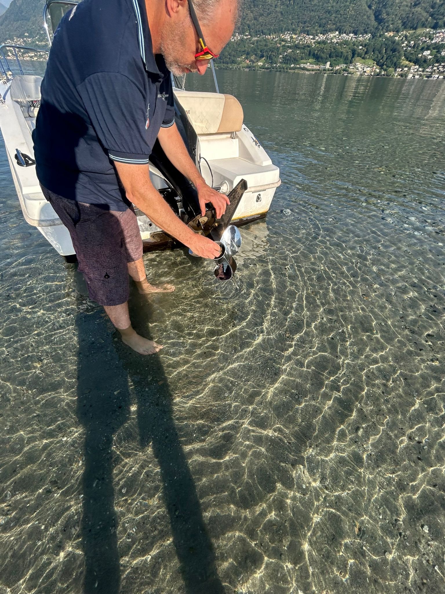Customer inspecting the propeller at the stern of the boat during the Suzuki 40 HP test