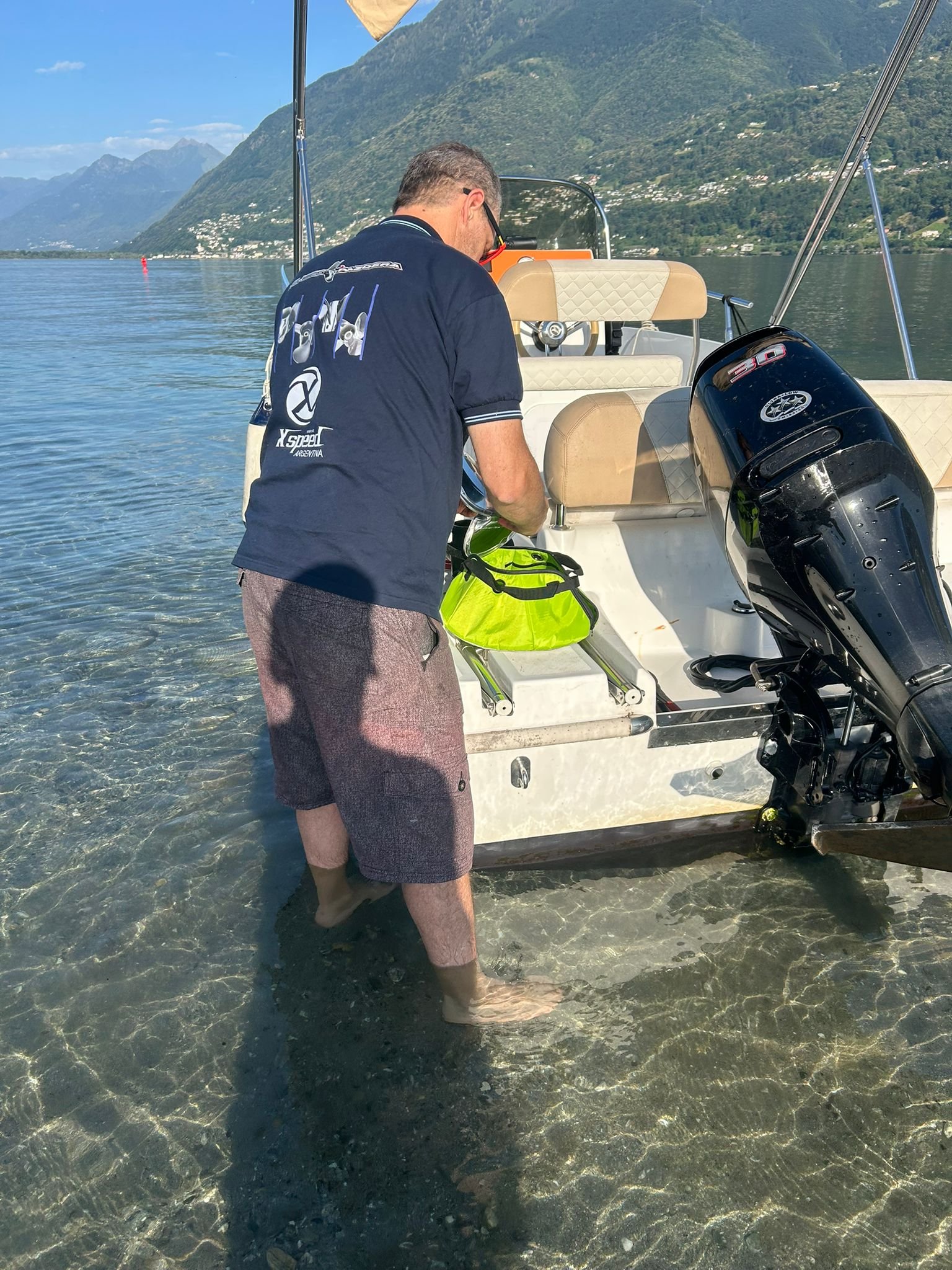 Customer checking an Xspeed stainless steel propeller on a Suzuki 40 HP outboard